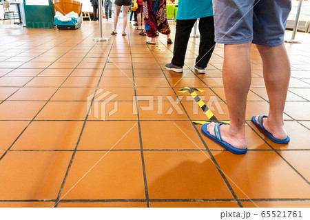 New normal social distancing with queue in line into supermarket in Malaysia 65521761
