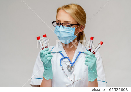medical doctor nurse woman wearing protective mask and gloves - holding virus blood test tube 65525808