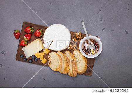 Cheese, wine bread and strawberries. 65526562