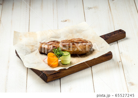 Roasted grilled beef meat steak on wooden board Roasted grilled beef meat steak on wooden board 65527245