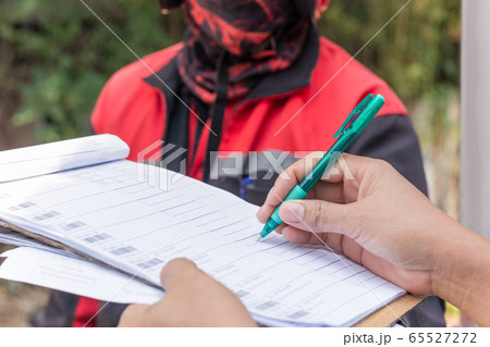 Delivery service female hands holding pen signing delivery document. Delivery service female hands holding pen signing delivery document. 65527272