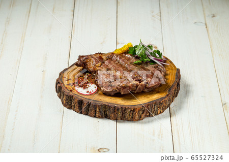 Roasted grilled beef meat steak on wooden board Roasted grilled beef meat steak on wooden board 65527324