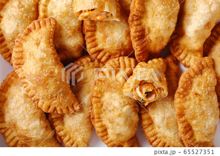 deep fried empanadas on a white paper deep fried empanadas on a white paper 65527351