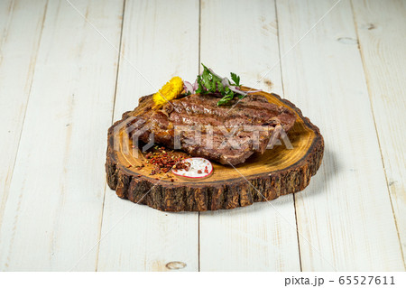Roasted grilled beef meat steak on wooden board Roasted grilled beef meat steak on wooden board 65527611