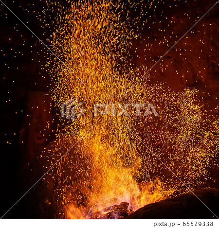 Smithy fire flame tips with sparks closeup Smithy fire flame tips with sparks closeup 65529338