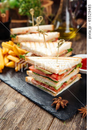 Tasty sandwiches with ham and vegetables Tasty sandwiches with ham and vegetables 65529485