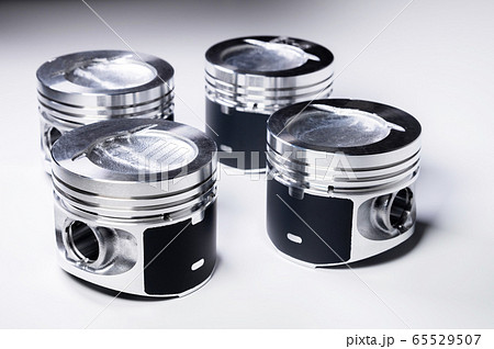 New parts for the internal combustion engine. Pistons on a gray gradient background New parts for the internal combustion engine. Pistons on a gray gradient background 65529507