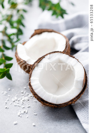 Coconut halves on concrete background 65533208
