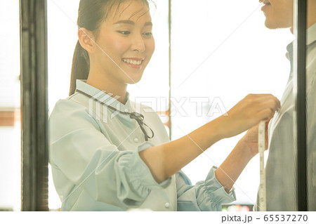 若い 可愛い 女性 デザイナー 洋服 衣装 測る デザイン 人物 素材の写真素材