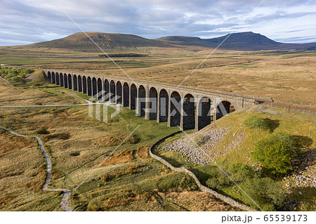 A drone shot of The Ribblehead Viaduct a Grade II listed structure, the Viaduct runs the Settle to Carlisle railway route in North Yorkshire, England. 65539173