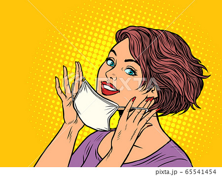 woman puts on a medical mask woman puts on a medical mask 65541454