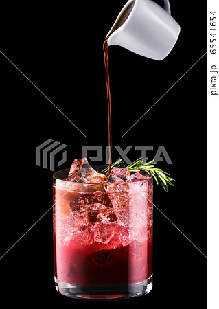 Pouring espresso in tonic with cherry juice 65541654