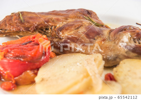 Baked leg of goat, with baked potatoes and roasted red peppers. Baked leg of goat, with baked potatoes and roasted red peppers. 65542112