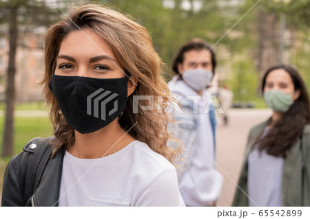 Young woman in white t-shirt, leather jacket and protective black textile mask Young woman in white t-shirt, leather jacket and protective black textile mask 65542899
