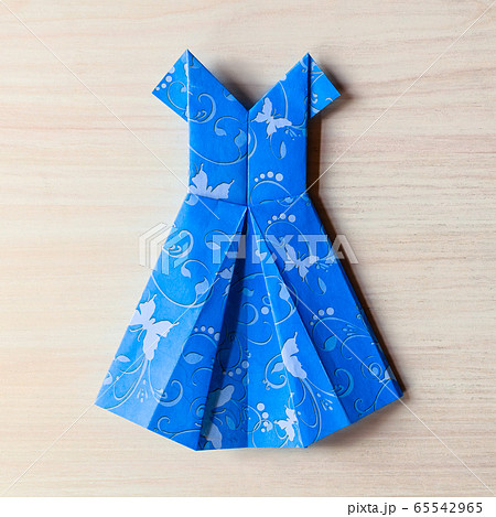 Origami made blue dress from butterfly printed paper. Mother's day, birhday, summer gift, fashion card. Family leisure time concept and game. Step by step instruction. DIY tutorial, flatlay, top view Origami made blue dress from butterfly printed paper. Mother's day, birhday, summer gift, fashion card. Family leisure time concept and game. Step by step instruction. DIY tutorial, flatlay, top view 65542965