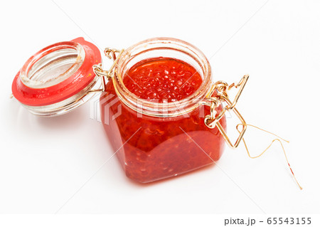 Red caviar in glass jar on white background 65543155