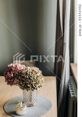 decorative flowers glass vase table inside house 65543492