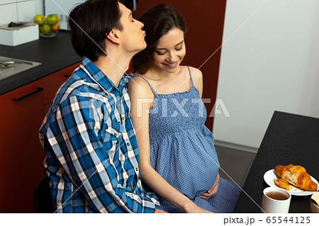 Happy man kissing future mother of his children 65544125