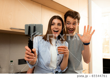 Man and woman making selfie by mobile phone at home 65544761