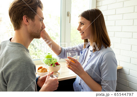 Young smiling couple enjoying tea at home 65544797