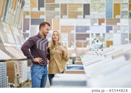 married couple are shopping together, looking for discounted things in market married couple are shopping together, looking for discounted things in market 65544828