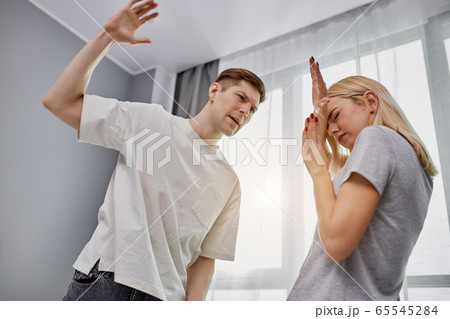 angry cruel man doesn't love his wife, beats her 65545284
