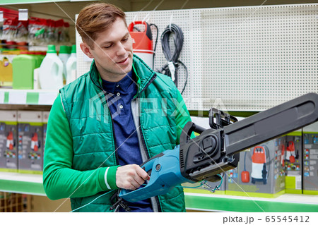 young caucasian salesman hold equipment in market 65545412