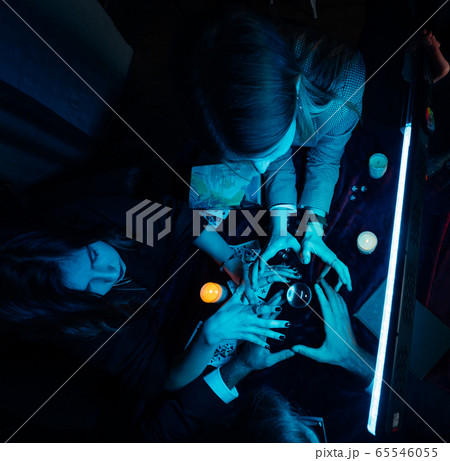 Group of people and woman fortune teller with crystal ball 65546055