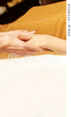 body arm stone massage. Hot rock masseur. Girl at salon with doctor hands. Relax 65546218