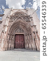 Arched entrance with sculptures and bas-reliefs to the Gothic temple 65546339