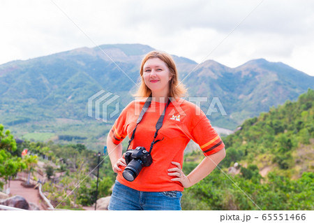 Vietnam, october of 2019. Park in Nha Trang city. Woman with camera Canon stay in the park 65551466