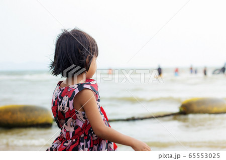 Girl on the beach. 65553025