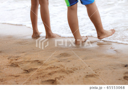 Children are walking on beach. 65553068