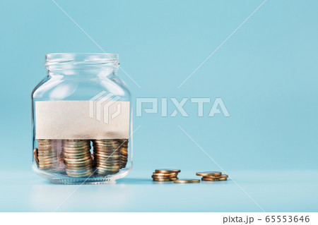 A glass jar with coins and a sticker with free A glass jar with coins and a sticker with free 65553646