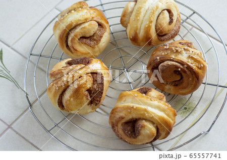 おうちでパン作り　シナモンロール　焼きたてのシナモンロールを網の上に並べている 65557741