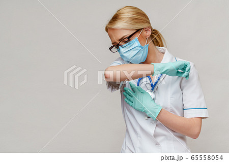 medical doctor nurse woman wearing protective mask and rubber or latex gloves - cough medical doctor nurse woman wearing protective mask and rubber or latex gloves - cough 65558054