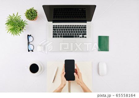 Businesswoman checking text messages Businesswoman checking text messages 65558164