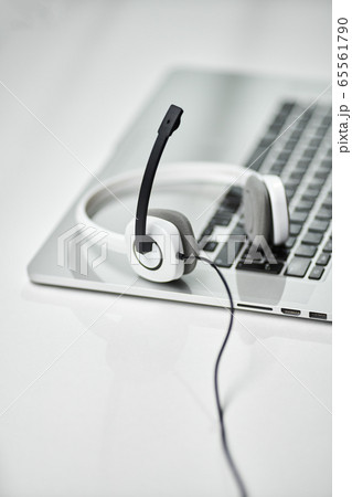 Top view of laptop, headphones with black microphone on table . Call center support Top view of laptop, headphones with black microphone on table . Call center support 65561790