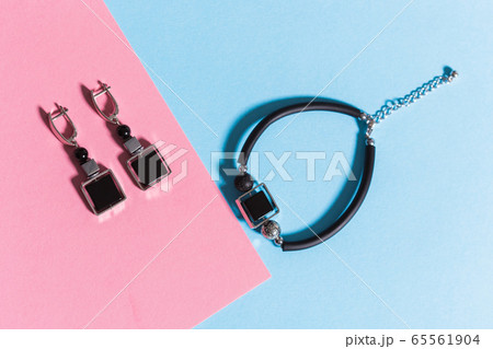 Top view of fashion jewelry and accessories on bright color background. Luxurious jewelry bijouterie and trendy concept. Top view of fashion jewelry and accessories on bright color background. Luxurious jewelry bijouterie and trendy concept. 65561904