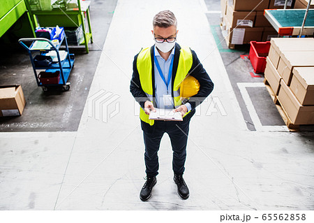 Top view of technician or engineer with protective mask standing in industrial factory. 65562858