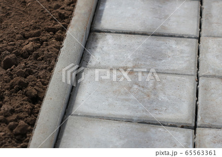 Concrete or cobble gray square pavement slabs or stones for sidewalk, road paving Concrete or cobble gray square pavement slabs or stones for sidewalk, road paving 65563361