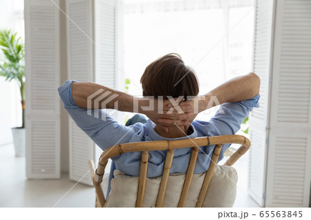 Back view of Caucasian man relax in chair at home 65563845