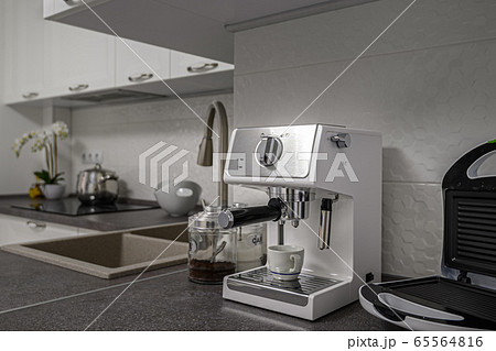 Espresso coffee maker in minimalistic white kitchen interior Espresso coffee maker in minimalistic white kitchen interior 65564816