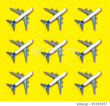 Pattern made of model airplane on yellow background. 65565657