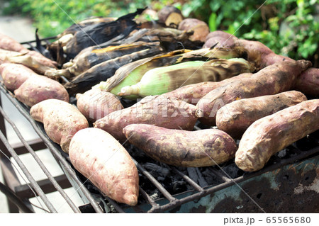 Yam burned and Burnt corn with charcoal on the grid iron Yam burned and Burnt corn with charcoal on the grid iron 65565680