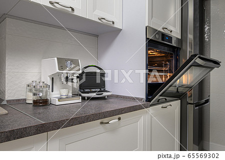 Electric appliances in minimalistic white kitchen interior Electric appliances in minimalistic white kitchen interior 65569302