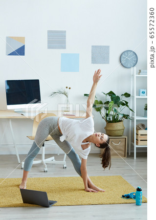 Young Woman Enjoying Workout at Home Young Woman Enjoying Workout at Home 65572360