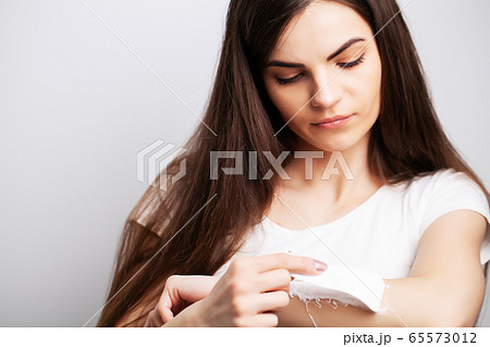 Young woman doing hair removal at home in the hands area Young woman doing hair removal at home in the hands area 65573012