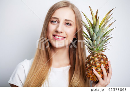 Natural cosmetics, beautiful woman face with pineapple. 65573063