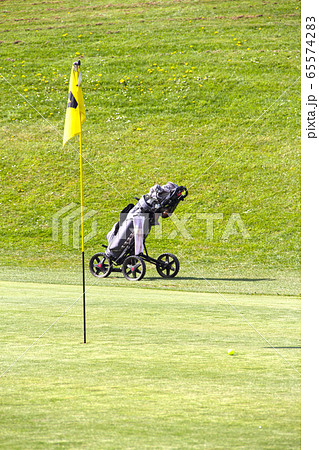 Flag and trolley the golf field Flag and trolley the golf field 65574283